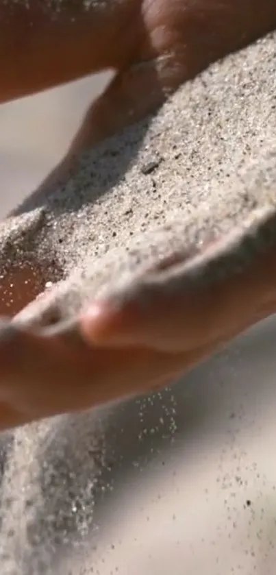 Close-up of hands letting sand flow freely.