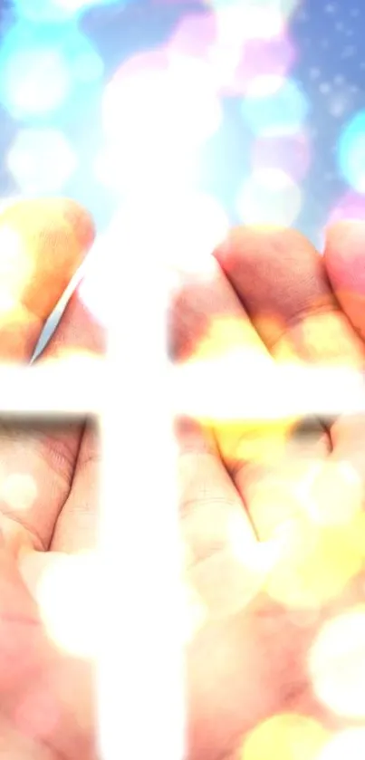 Hands holding a bright cross with colorful bokeh lights.