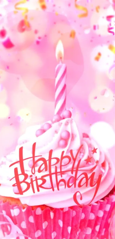 Pink Happy Birthday cupcake with candle and confetti.