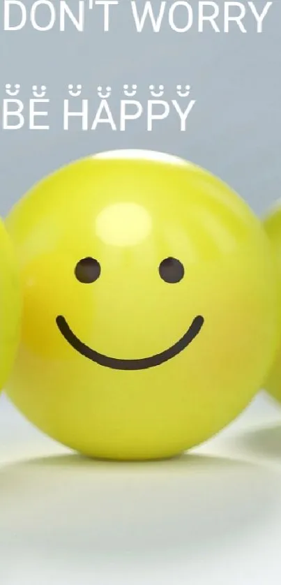 Happy yellow emoji with "Don't Worry, Be Happy" message on a wallpaper.