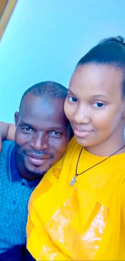 Father and daughter smiling together in a bright and colorful setting.