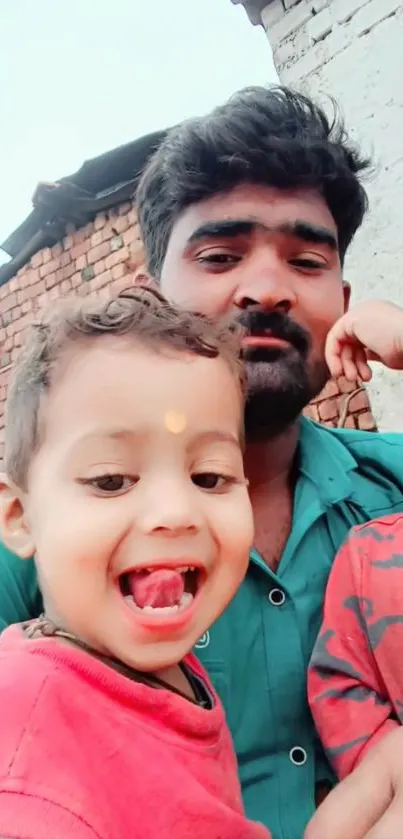 Father and children smiling outdoors with brick background.