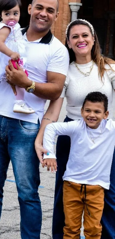 Happy family standing outdoors in casual attire.