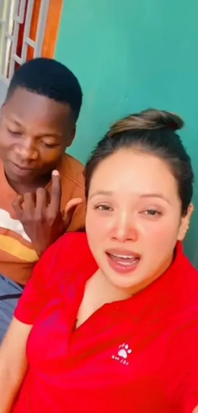 Two friends smiling in a vibrant selfie.