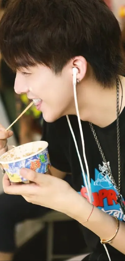 Person smiling with colorful ice cream in casual wear, enjoying music.