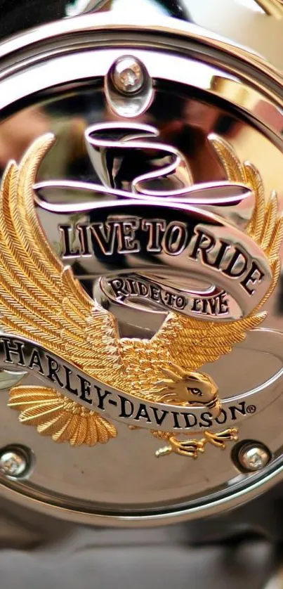 Harley-Davidson emblem with a golden eagle on a chrome surface.