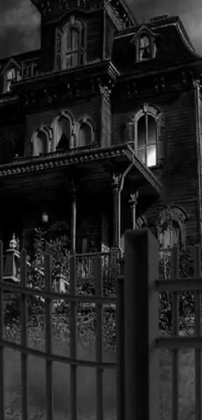 A black-and-white image of a haunted Gothic manor behind a fence.