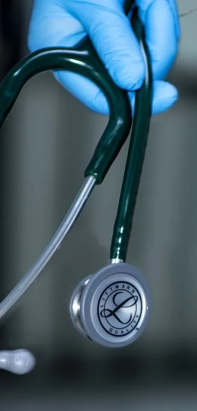 Healthcare professional holding a stethoscope with blue gloves.