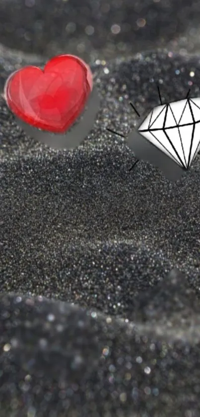 Red heart and diamond on glittery black surface.