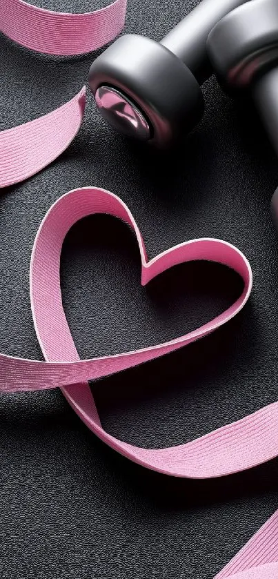 Pink ribbon heart with dumbbells on black background.