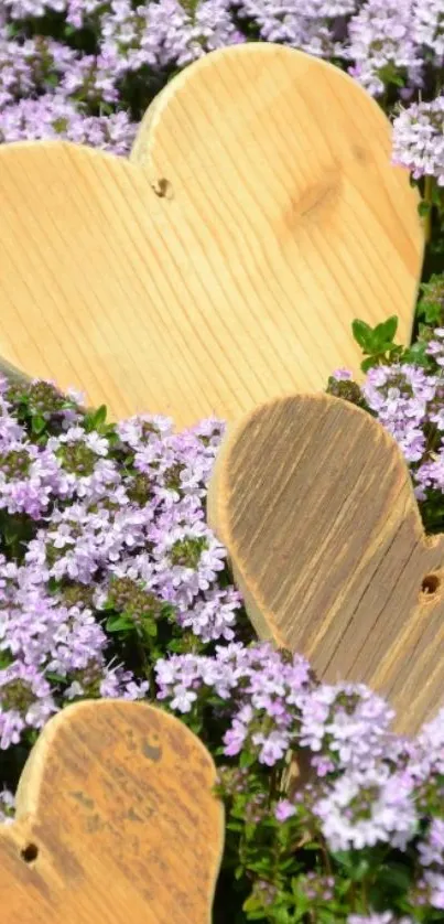 Wooden hearts on a bed of purple flowers.