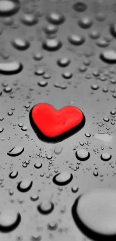 Red heart among gray raindrops on wallpaper background.