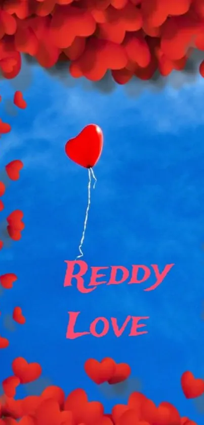 Red heart balloon floating in a bright blue sky.