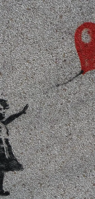 Street art of girl with red heart-shaped balloon on gray wall.