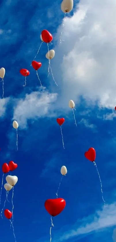 Heart-shaped balloons floating in a blue sky with clouds.