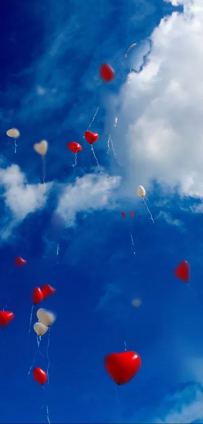 Heart-shaped balloons drifting in a vibrant blue sky with clouds.