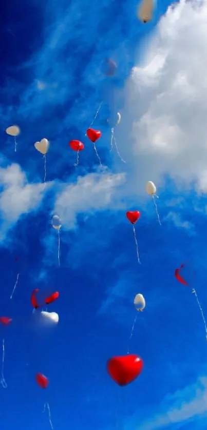 Heart-shaped balloons floating in a vibrant blue sky with white clouds.