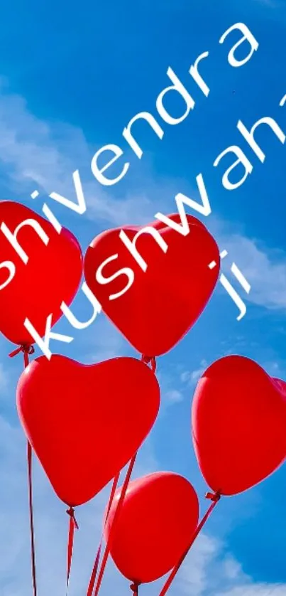 Red heart balloons float in a blue sky.