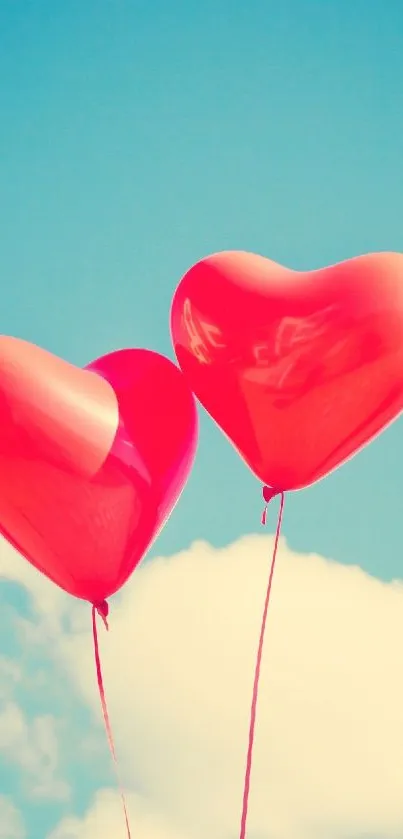 Red heart-shaped balloons float in a clear blue sky with fluffy clouds.