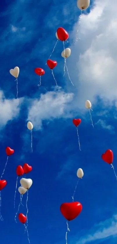 Heart-shaped balloons float in a bright blue sky with fluffy clouds.