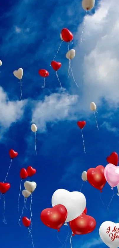 Colorful heart balloons against a blue sky with clouds.