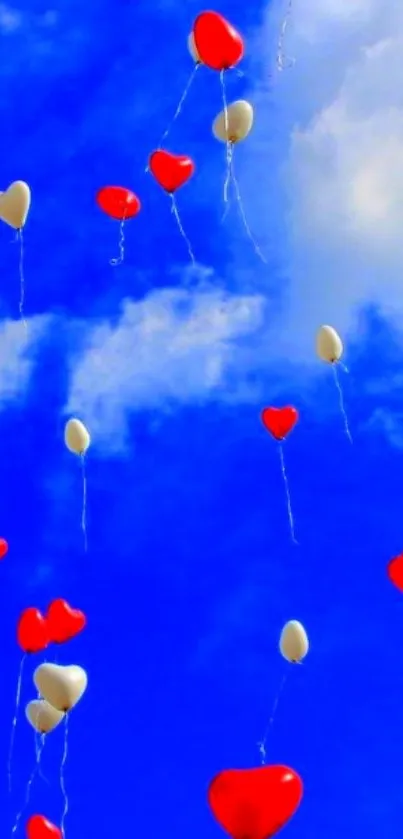 Heart-shaped balloons in blue sky with white clouds.