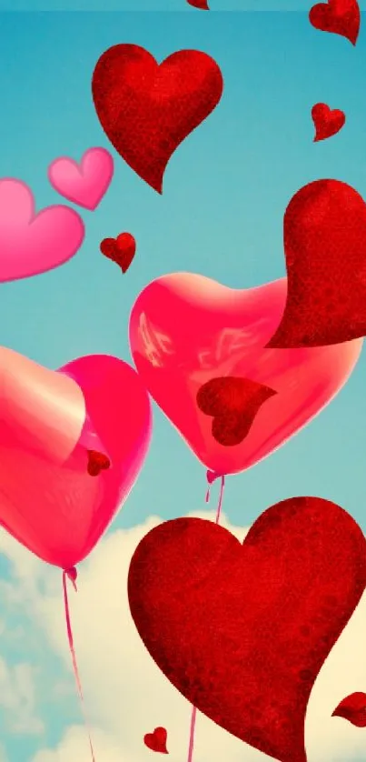 Red heart balloons floating against a vibrant blue sky with clouds.