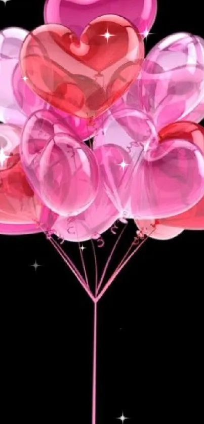 Heart-shaped balloons in pink and red on a black background.