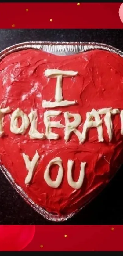 Heart-shaped cake with 'I Tolerate You' message on a mobile wallpaper.