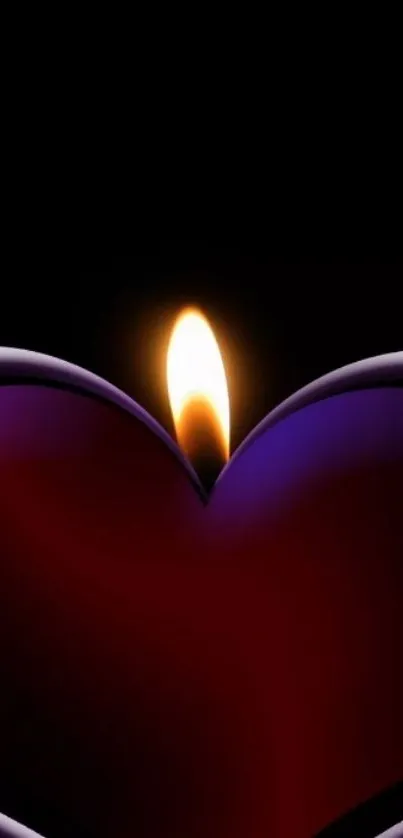 Heart-shaped candle with glowing flame on black background.