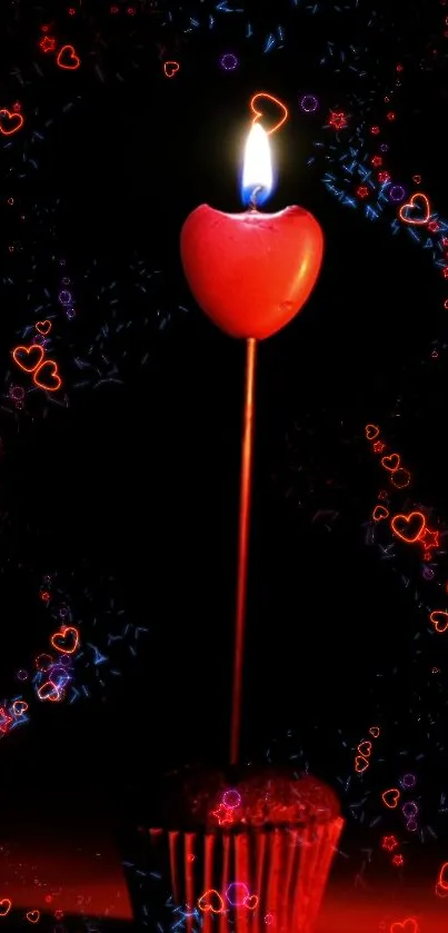 Heart-shaped candle with glowing red light against a dark background.