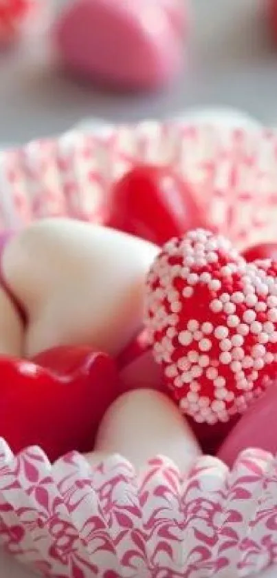 Heart-shaped candies in a decorative paper cup.