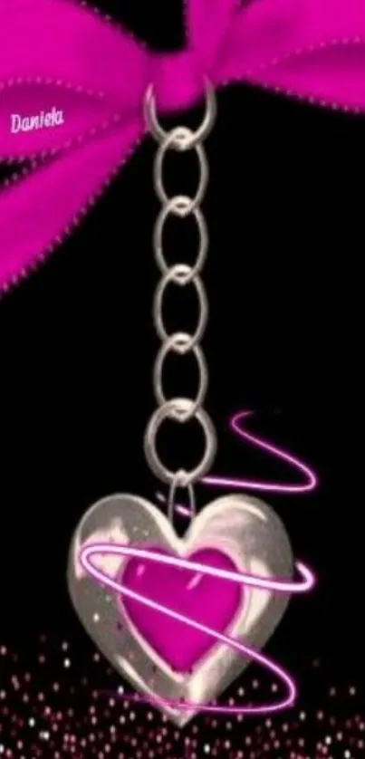 Pink heart charm hanging on a ribbon with glitter.