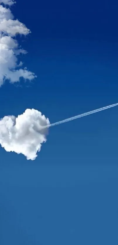 Heart-shaped cloud with airplane in blue sky.