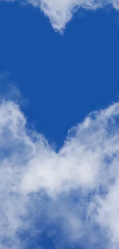 Heart-shaped cloud in a vivid blue sky with soft white clouds.