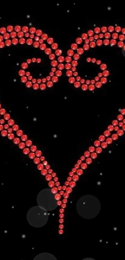 Red gemstone heart design on black background.