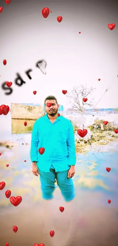 Man in blue shirt surrounded by red hearts by a lakeside.