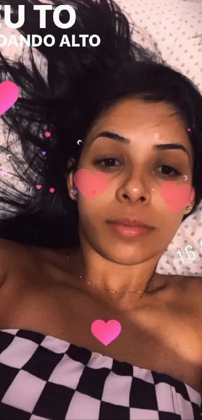 Woman with heart effects on face, lying down.