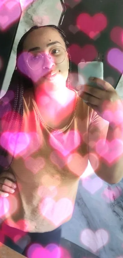 Mobile wallpaper with glowing pink hearts overlay and selfie.