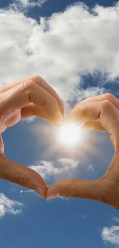 Hands forming heart with sun and sky background.