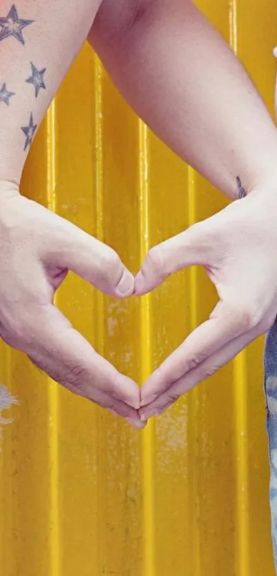 Hands forming a heart on a yellow backdrop.