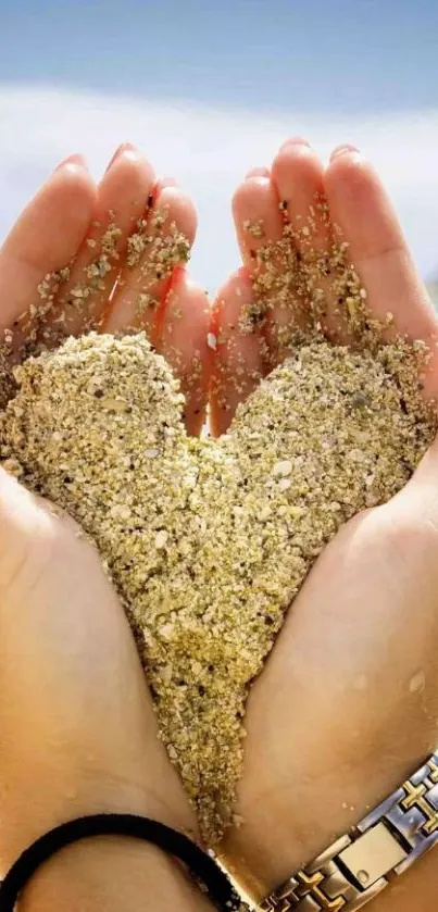 Heart shaped sand held by hands on a sunny beach background.