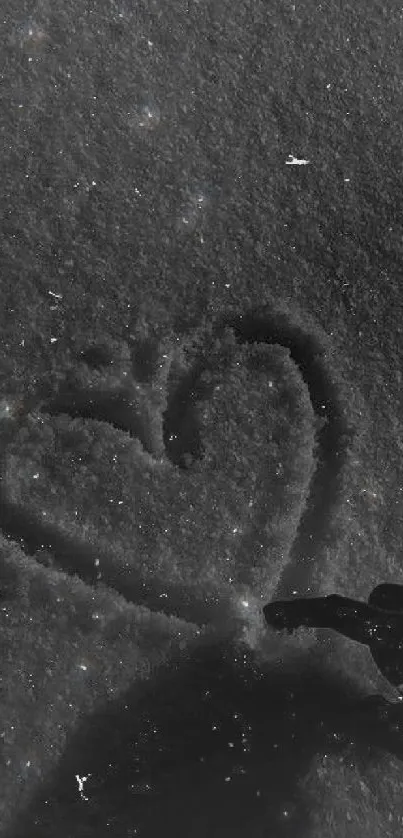 Heart drawn in snow with a dark, artistic touch.