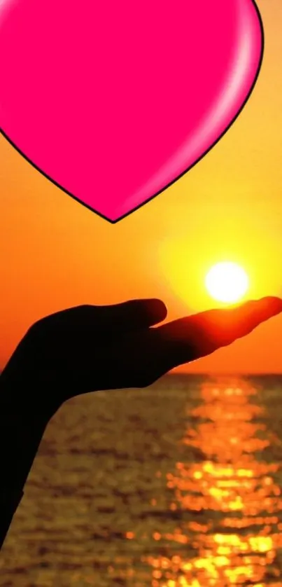 Silhouette of a hand holding sunset with a pink heart overlay.