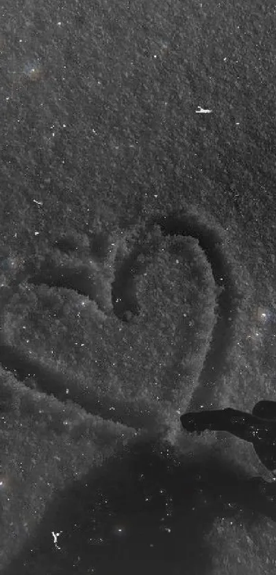 Monochrome heart drawn in the snow.