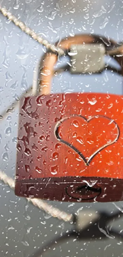 Red heart lock with raindrops on a fence.