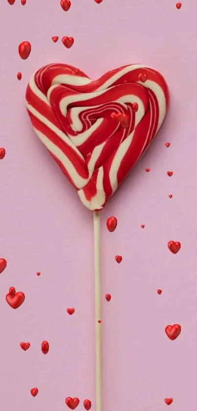 Heart-shaped lollipop on pink background wallpaper.