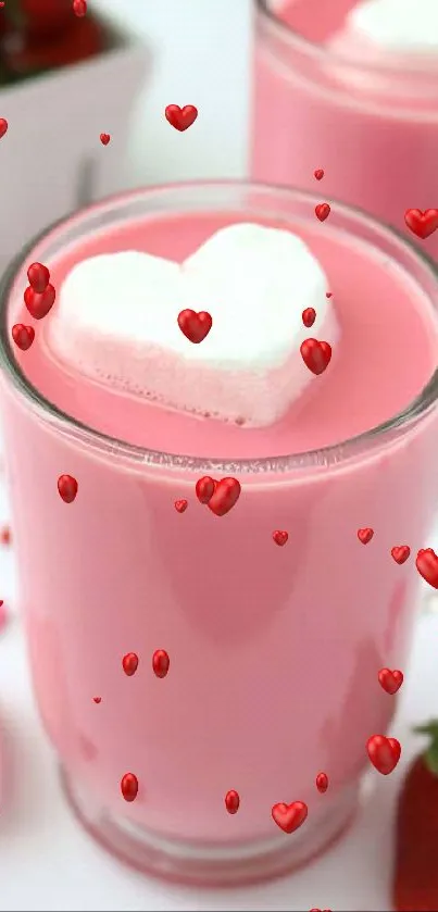 Two mugs of pink drink with heart-shaped marshmallows and strawberries.