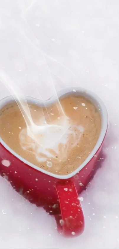 Heart-shaped red mug with coffee in snow.