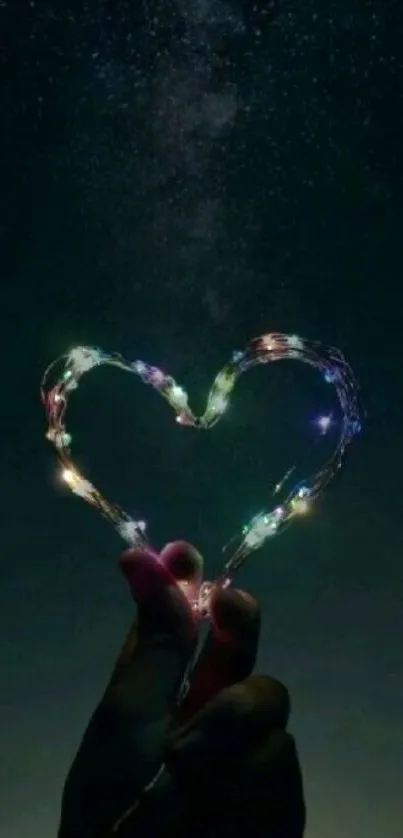 Heart-shaped lights held against a starry sky in a dark mobile wallpaper.